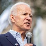 President Biden speaking into a microphone