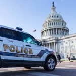 Police vehicle outside United States Capitol building.