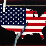 Scissors cutting USA map with flag pattern.
