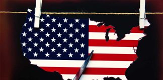Scissors cutting USA map with flag pattern.