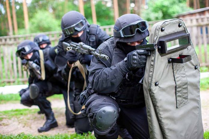 1841092291 featured image SWAT team members aiming rifles behind a protective shield.