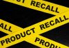 Yellow product recall tape on black background