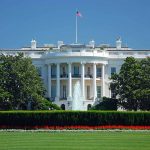 White House with American flag and fountain visible