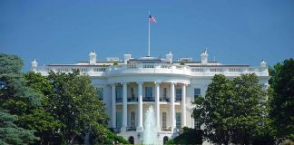 White House with American flag and fountain visible