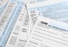 Tax forms and documents overlapping on surface