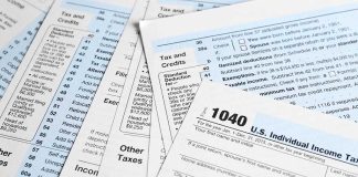 Tax forms and documents overlapping on surface