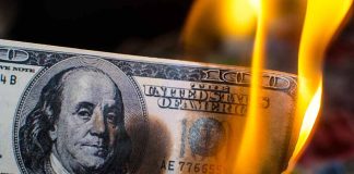 Burning hundred dollar bill with visible flames