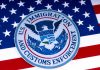 US Immigration and Customs Enforcement badge on flag