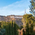 Hollywood sign on hill surrounded by trees and buildings
