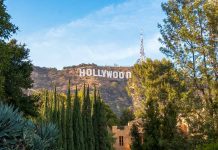 Hollywood sign on hill surrounded by trees and buildings