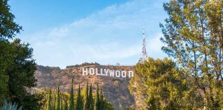 Hollywood sign on hill surrounded by trees and buildings