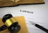 Lawsuit document with gavel pen and open book
