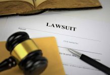 Lawsuit document with gavel pen and open book
