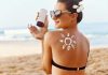Woman applying sunscreen at the beach