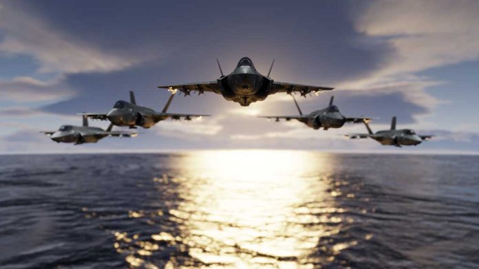 Five jets flying low over the ocean at sunset