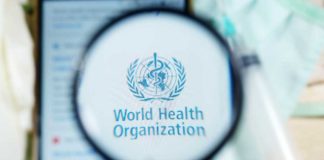 Magnifying glass focused on World Health Organization logo