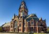 Large ornate brick building with a tall tower