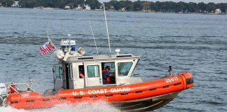 U S Coast Guard boat speeding on water