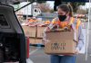 Person carrying food bank box to car
