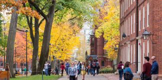 People walking on a college campus in autumn