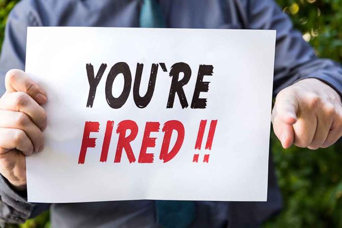 388134190 featured image Person holding you're fired sign