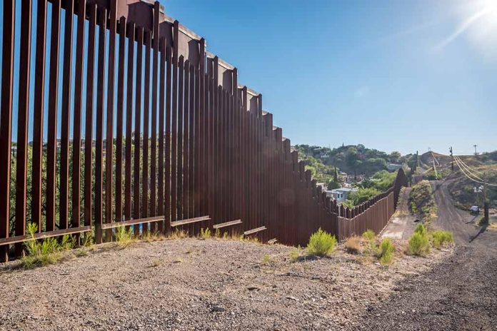 657897121 featured image Tall metal border wall with rural landscape