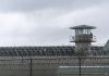 Guard tower and barbed wire at a prison facility