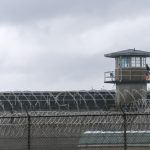 Guard tower and barbed wire at a prison facility
