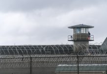 Guard tower and barbed wire at a prison facility