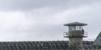 Guard tower and barbed wire at a prison facility