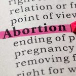 Abortion highlighted in a dictionary with a pink marke