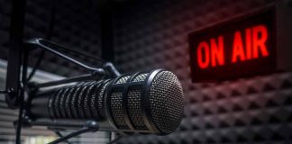 Microphone in soundproof studio with On Air sign