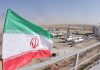 Iranian flag near an industrial gas refinery