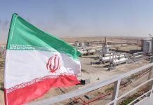 Iranian flag near an industrial gas refinery