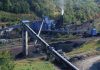 Industrial coal processing plant with conveyor belts and smokestack