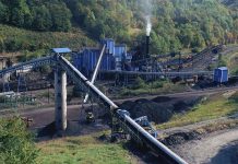 Industrial coal processing plant with conveyor belts and smokestack