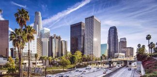 Downtown cityscape with skyscrapers and highway traffic