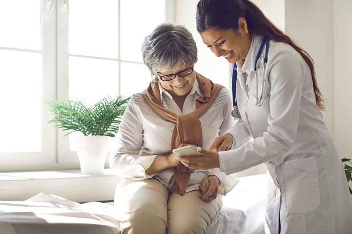 1968439885 featured image Doctor showing phone to a smiling elderly woman