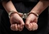 Hands in handcuffs behind persons back