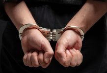 Hands in handcuffs behind persons back