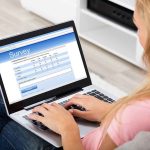Person filling survey on a laptop