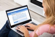 Person filling survey on a laptop