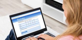 Person filling survey on a laptop