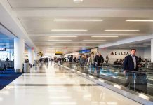 People walking through a busy airport terminal