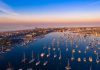 Aerial view of marina at sunset with many boats