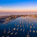 Aerial view of marina at sunset with many boats