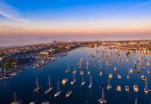 Aerial view of marina at sunset with many boats