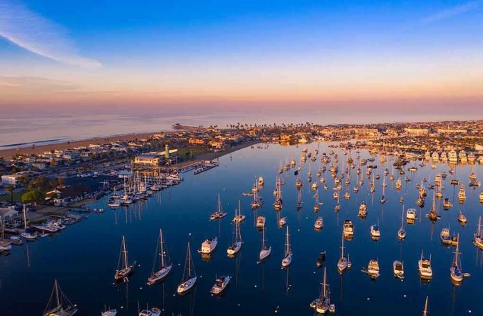 1266971521 Aerial view of marina at sunset with many boats