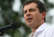 Man speaking into microphone outdoors
