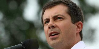 Man speaking into microphone outdoors